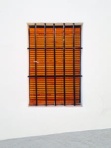 brown window blinds hang on window thumbnail