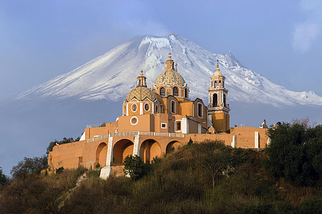 brown dome building near mountain under blue sky at daytime thumbnail