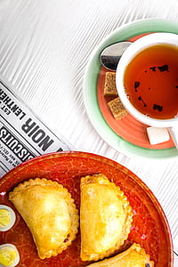 teacup and breads on top of saucers thumbnail