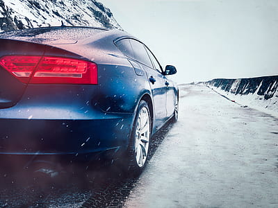 black sedan on snow covered road thumbnail