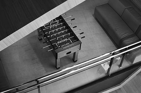 grayscale photo of foosball table thumbnail