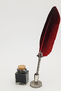 gray and red fountain pen with red feather beside ink bottle thumbnail