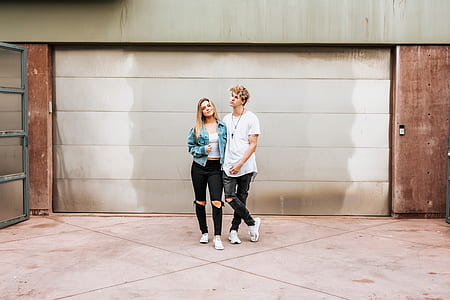 couple standing near garage door thumbnail