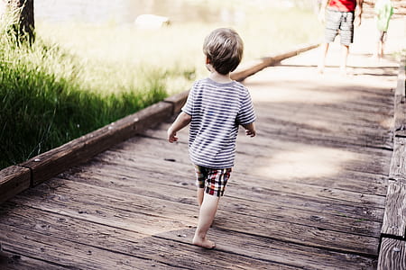 boy walking on boat dock thumbnail