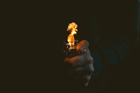 person holding a lighted lighter thumbnail