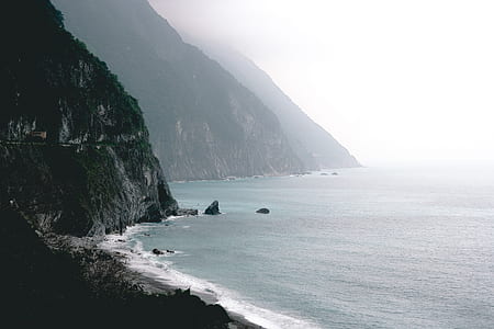 silhouette of mountain in front of seashore thumbnail