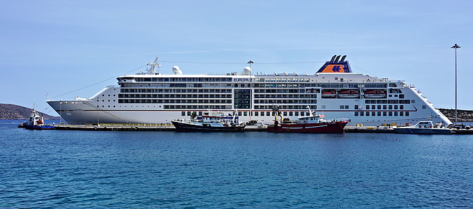 white and black cruise ship near the black wooden dock at daytime thumbnail