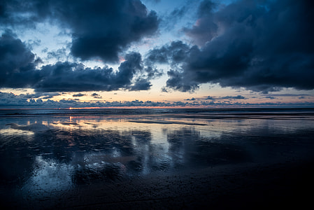 body of water under cloudy sky thumbnail