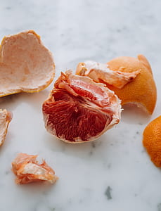 peeled orange on white surface thumbnail