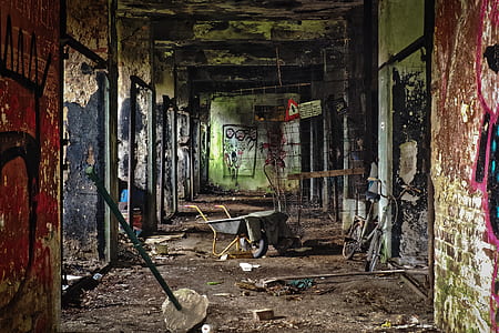 wheelbarrow in middle of hallway in damage building thumbnail