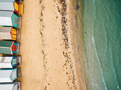 assorted-color houses beside large body of water thumbnail