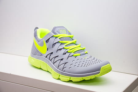 unpaired gray and green Nike running shoe thumbnail