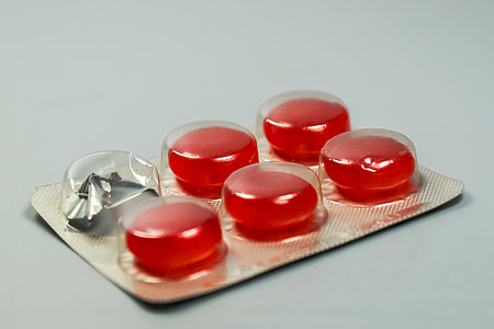 five red medication tablets inside blister pack thumbnail