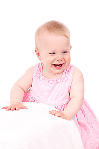 baby laughing and wearing pink and white floral dress with white background thumbnail