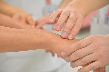 person massaging another person's hand thumbnail