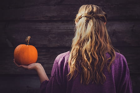 Woman Holding Squash Near Wooden Wall thumbnail