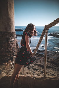 woman holding gray rope near post thumbnail