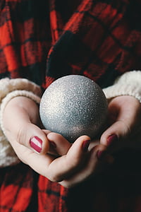 person holding gray baubles thumbnail