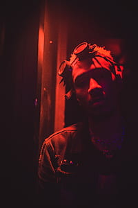 man wearing goggles leaning on glass window thumbnail