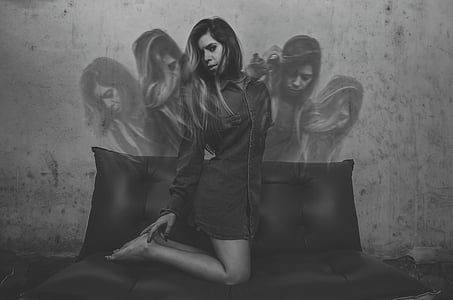woman kneeling on sofa grayscale photo thumbnail