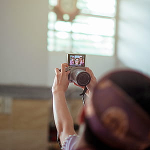 Person Holding Gray Dslr Camera thumbnail