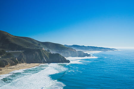 sea shore beside mountain photo thumbnail