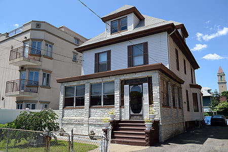 white, gray, and brown 3-story house under clear blue sky thumbnail