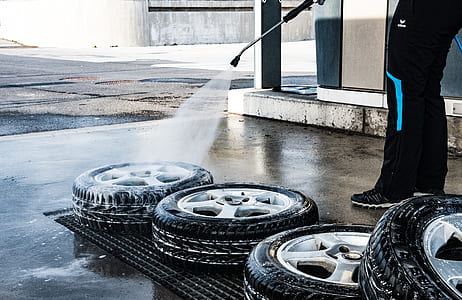 person washing chromed 5-spoke vehicle wheel set thumbnail
