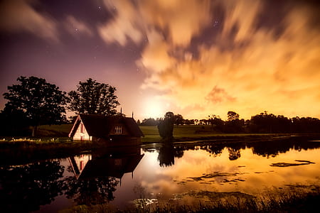 timelapse photography of house near body of water thumbnail
