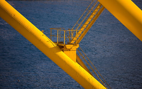 yellow metal stair in tower during daytime thumbnail