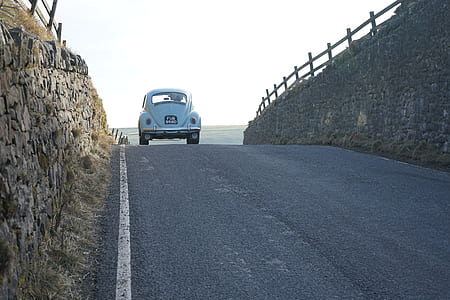 teal Volkswagen Beetle coupe on road during daytime thumbnail