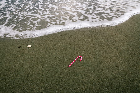 White and Red Christmas Candy on Beach Sand thumbnail