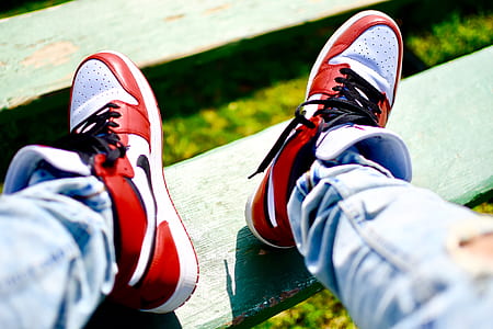 person wearing red-white-and-black Nike high-top sneakers thumbnail