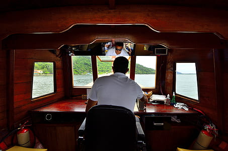 Man Sitting on the Chair While Observing Outside during Daytime thumbnail
