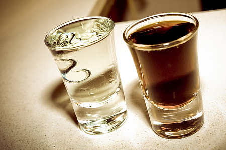 two clear drinking glasses filled with liquid thumbnail