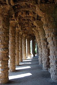 brown concrete columns near trees thumbnail