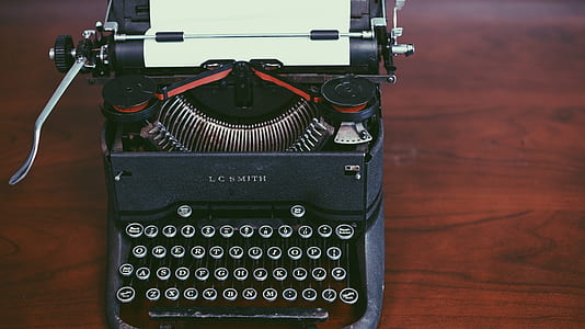 top view photography of black and white typewriter thumbnail