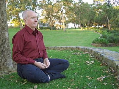 man wearing red dress shirt sitting near the tree thumbnail