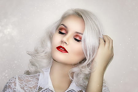 woman in white top holding her hair thumbnail
