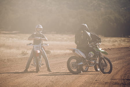 two men riding motocross dirt bikes thumbnail