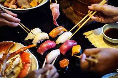 people getting sushi from grill thumbnail