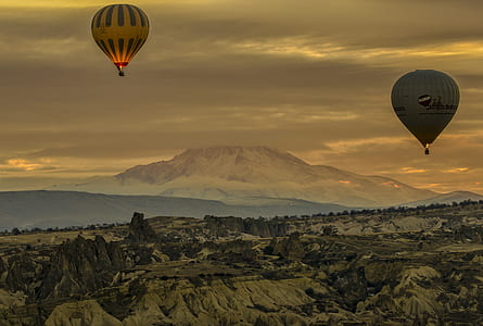 two gray and brown air balloons on air below ground at daytime thumbnail