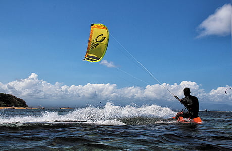 man on body of water while kite boarding thumbnail
