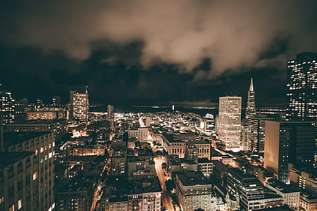 aerial photo of buildings with lights at night thumbnail