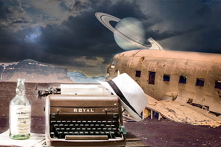gray and black Royal typewriter and white fedora hat thumbnail
