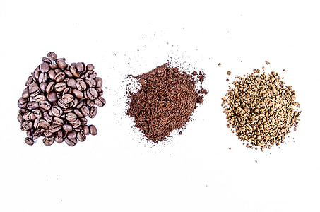 coffee beans and two black and beige powders on white surface thumbnail