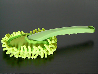 green handheld mop on brown wooden surface thumbnail