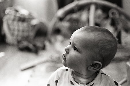 grayscale photo of toddler looking up thumbnail