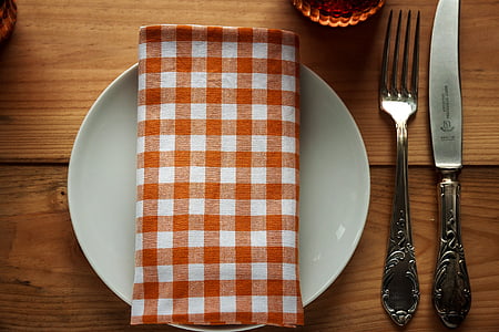 white ceramic plate beside fork and knife thumbnail