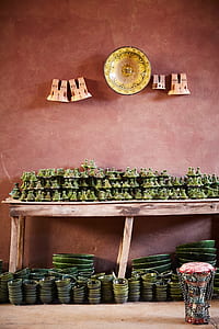 green ceramic lid and bowl lot on brown wooden rack thumbnail